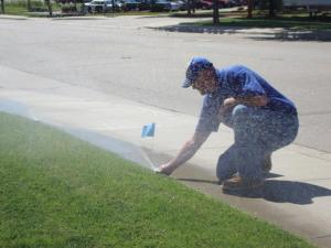 one of our Vacaville sprinkler repair techs is adjusting a sprinkler head